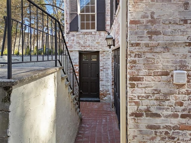 view of exterior entry with brick siding