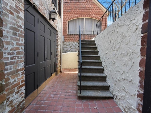 property entrance featuring brick siding