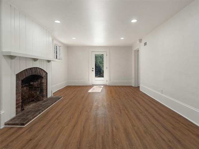 unfurnished living room featuring a fireplace, recessed lighting, wood finished floors, and baseboards