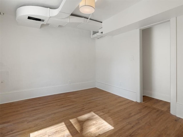 unfurnished room featuring baseboards and wood finished floors