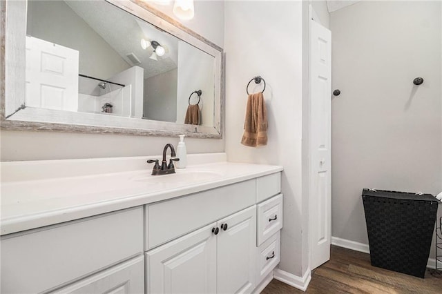 28 Fawn Ct, Sharpsburg, GA 30277 - bathroom featuring vanity, wood finished floors, lofted ceiling, and a shower
