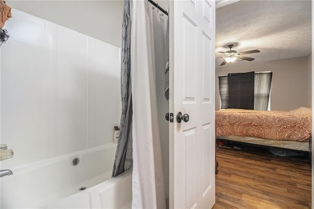 28 Fawn Ct, Sharpsburg, GA 30277 - ensuite bathroom with shower / bath combination with curtain, wood finished floors, ceiling fan, and a textured ceiling