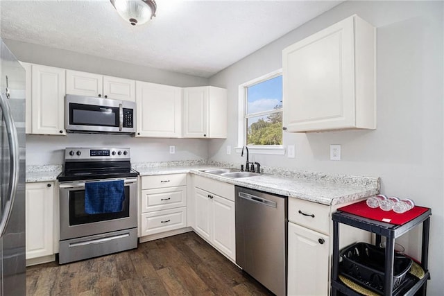 28 Fawn Ct, Sharpsburg, GA 30277 - kitchen featuring stainless steel appliances, dark wood finished floors, and white cabinetry