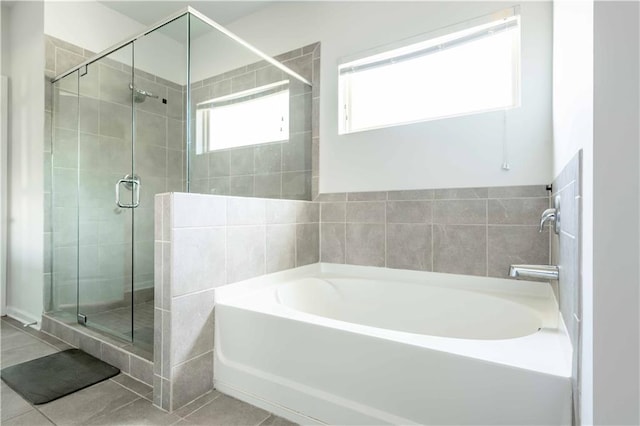 2649 Ogden Trl, Buford, GA 30519 - bathroom featuring a garden tub, a stall shower, and tile patterned flooring