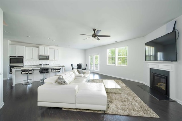 2649 Ogden Trl, Buford, GA 30519 - living room with ceiling fan, baseboards, a glass covered fireplace, dark wood-style floors, and recessed lighting