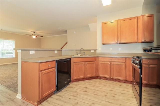 kitchen featuring kitchen peninsula, gas range, sink, dishwasher, and light hardwood / wood-style floors