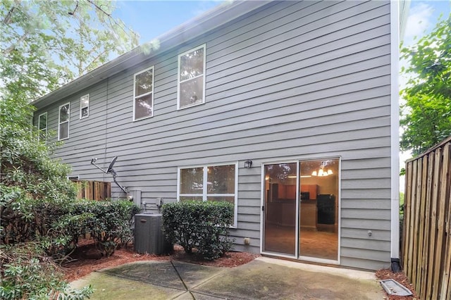 rear view of house with cooling unit and a patio area