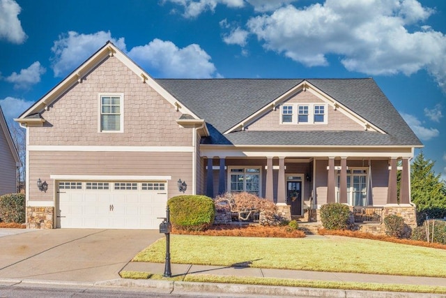 craftsman-style house with a front lawn, a porch, and a garage