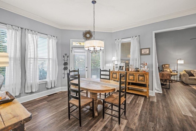 dining area featuring dark wood-type flooring, a wealth of natural light, and a chandelier