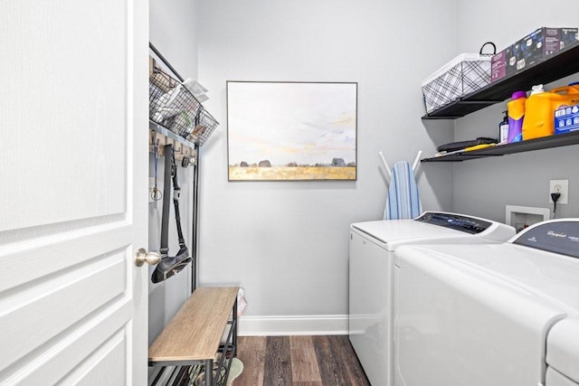 clothes washing area with washing machine and dryer and dark hardwood / wood-style floors