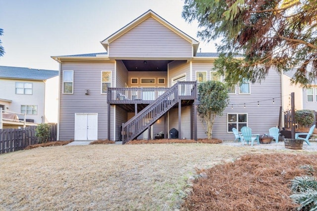 rear view of house featuring a deck and a fire pit