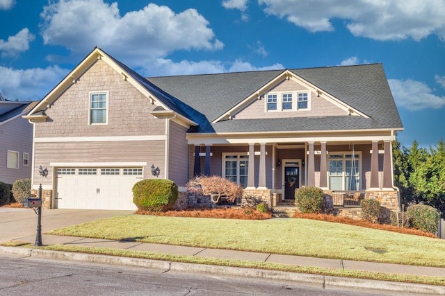 craftsman house with a front yard, a garage, and a porch