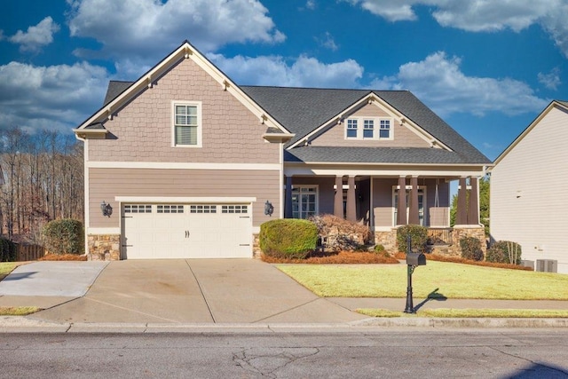 craftsman inspired home featuring a front yard, central AC, covered porch, and a garage