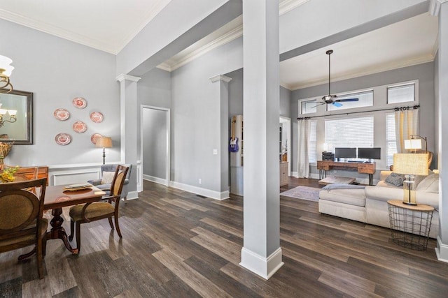 living room featuring ceiling fan, dark hardwood / wood-style floors, a high ceiling, and decorative columns