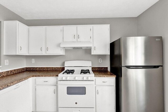 1234 Wellhouse Walk, Stone Mountain, GA 30088 - kitchen featuring freestanding refrigerator, gas range gas stove, ventilation hood, dark countertops, and white cabinetry