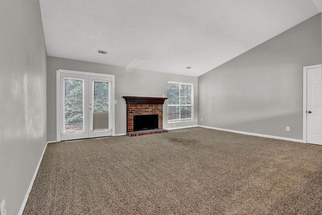 1234 Wellhouse Walk, Stone Mountain, GA 30088 - unfurnished living room featuring carpet, vaulted ceiling, french doors, and a fireplace