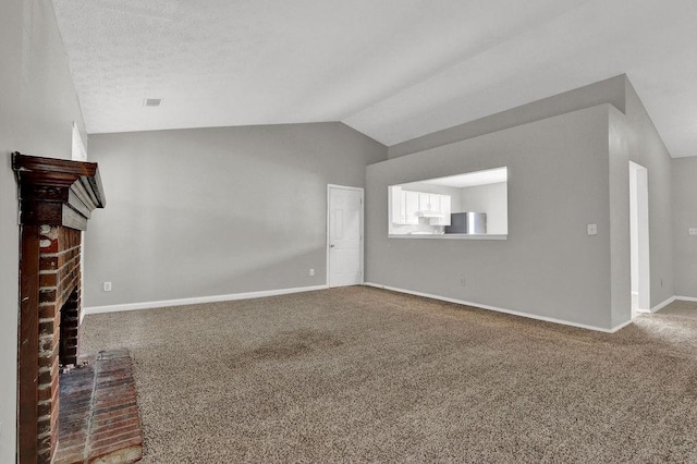 1234 Wellhouse Walk, Stone Mountain, GA 30088 - unfurnished living room featuring a fireplace, vaulted ceiling, and carpet floors