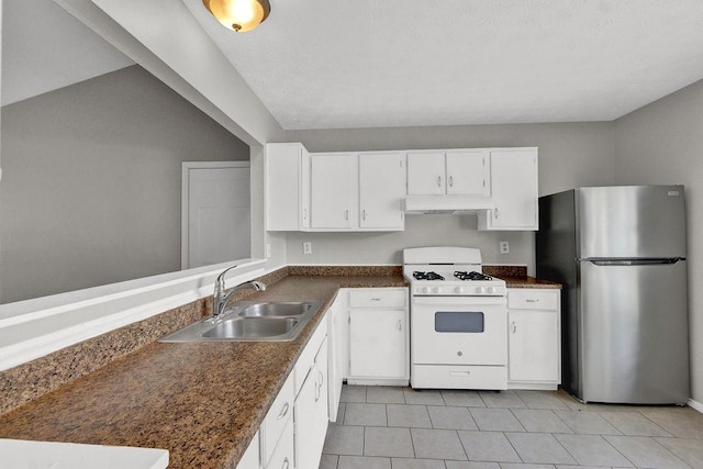 1234 Wellhouse Walk, Stone Mountain, GA 30088 - kitchen featuring freestanding refrigerator, gas range gas stove, under cabinet range hood, dark countertops, and white cabinets