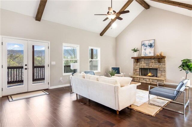 unfurnished living room with high vaulted ceiling, dark hardwood / wood-style floors, a fireplace, and french doors