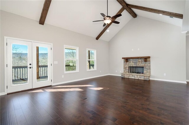 unfurnished living room featuring ceiling fan, a fireplace, dark hardwood / wood-style floors, and beamed ceiling