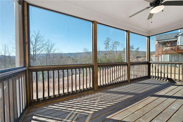 wooden deck with a sunroom