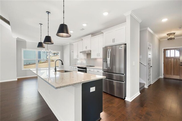 kitchen featuring sink, white cabinets, hanging light fixtures, stainless steel refrigerator with ice dispenser, and a center island with sink