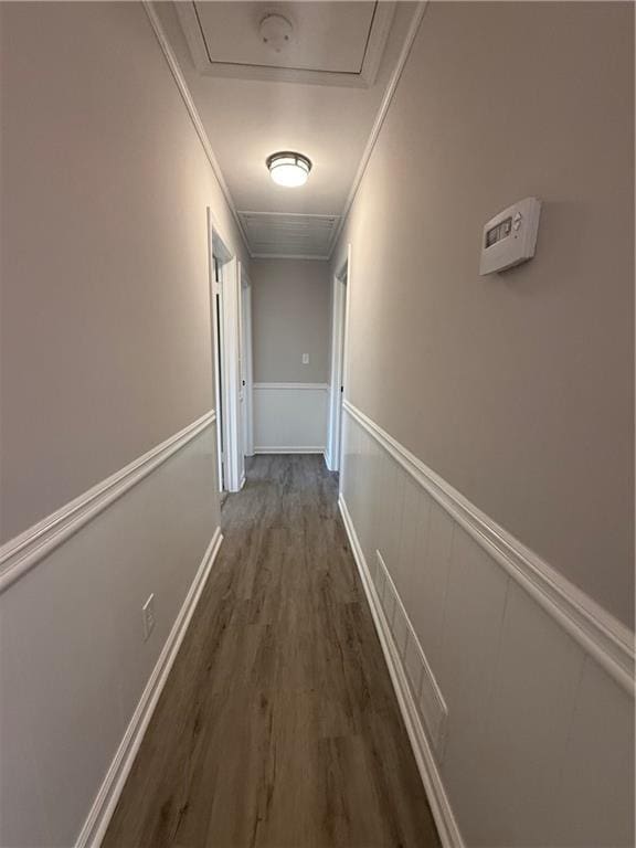 corridor with dark hardwood / wood-style flooring and ornamental molding