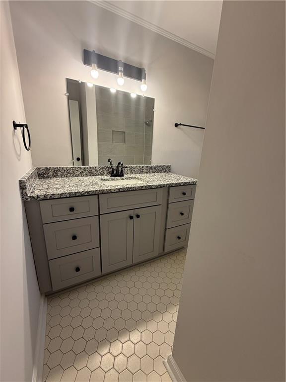 bathroom with vanity and ornamental molding