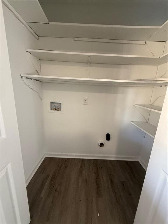 clothes washing area with dark hardwood / wood-style flooring and hookup for a washing machine