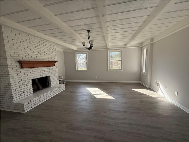 unfurnished living room with a fireplace, beamed ceiling, a chandelier, dark wood-type flooring, and wooden ceiling