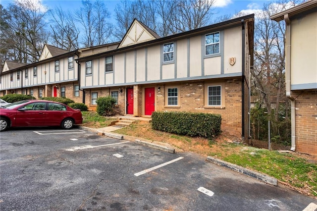 1150 Rankin St Unit 6H, Stone Mountain, GA 30083 - view of property featuring brick siding, uncovered parking, and board and batten siding