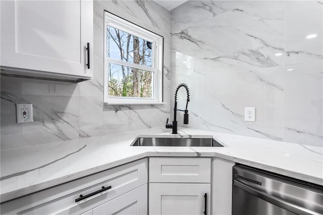 1150 Rankin St Unit 6H, Stone Mountain, GA 30083 - kitchen featuring dishwasher, white cabinets, backsplash, and light stone countertops