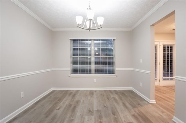 7113 Ambercrest Ct, Austell, GA 30168 - unfurnished dining area with a chandelier, wood finished floors, baseboards, ornamental molding, and a textured ceiling