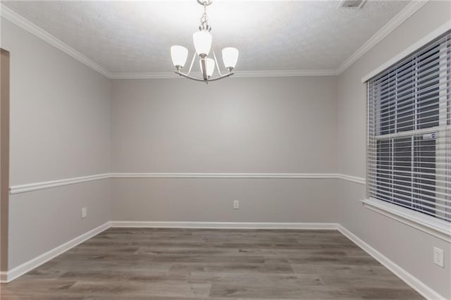 7113 Ambercrest Ct, Austell, GA 30168 - spare room featuring a chandelier, wood finished floors, a textured ceiling, ornamental molding, and baseboards