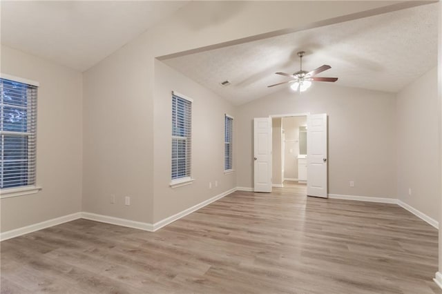 7113 Ambercrest Ct, Austell, GA 30168 - unfurnished room featuring lofted ceiling, a ceiling fan, light wood-type flooring, and baseboards