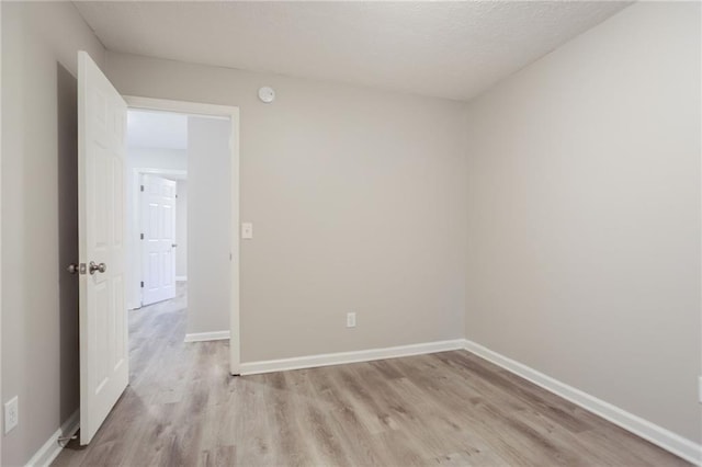 7113 Ambercrest Ct, Austell, GA 30168 - unfurnished room featuring light wood-style floors, baseboards, and a smoke detector