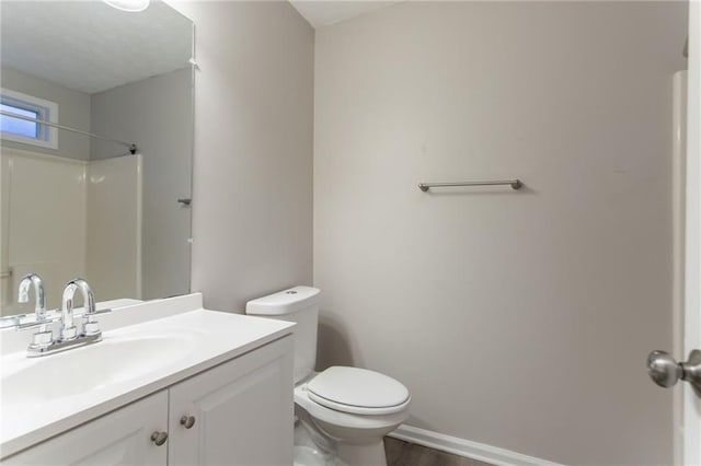 7113 Ambercrest Ct, Austell, GA 30168 - bathroom featuring toilet, vanity, a shower, wood finished floors, and baseboards