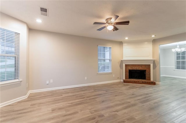 7113 Ambercrest Ct, Austell, GA 30168 - unfurnished living room with a ceiling fan, light wood-style flooring, baseboards, a chandelier, and recessed lighting