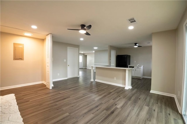 unfurnished living room with dark hardwood / wood-style floors and ceiling fan