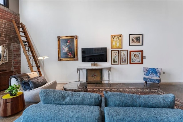 living room with baseboards and a towering ceiling