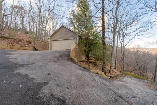 exterior space featuring an outbuilding and a garage