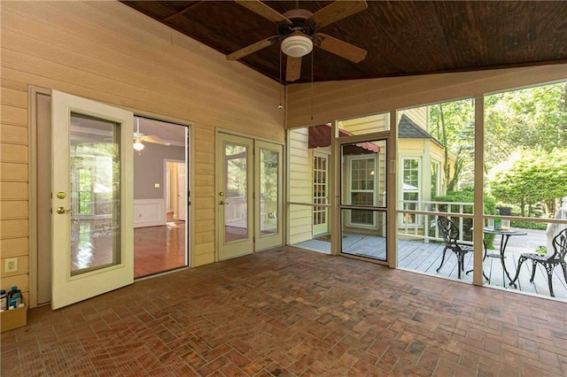 unfurnished sunroom with ceiling fan and french doors