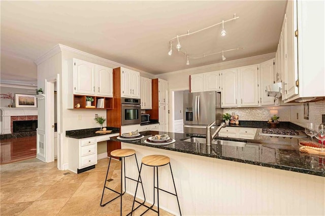 kitchen with stainless steel appliances, a sink, crown molding, a peninsula, and ventilation hood