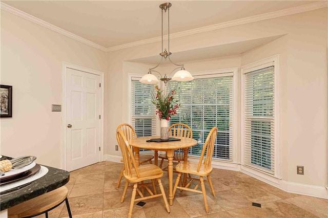 dining room with ornamental molding and baseboards