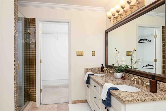 full bathroom featuring a walk in closet, crown molding, double vanity, a tile shower, and tile patterned flooring