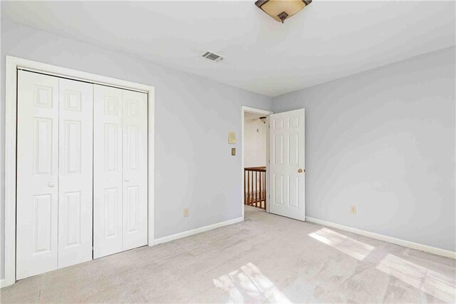 unfurnished bedroom featuring carpet flooring, a closet, and baseboards