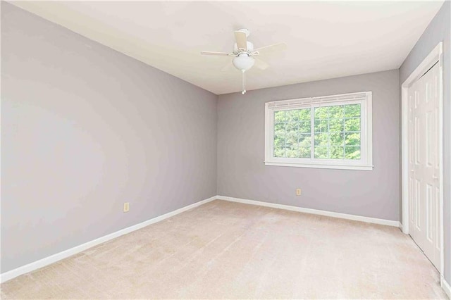 unfurnished bedroom with baseboards, a closet, and light carpet