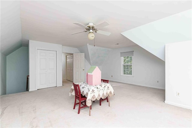bonus room with lofted ceiling, carpet flooring, a ceiling fan, and baseboards