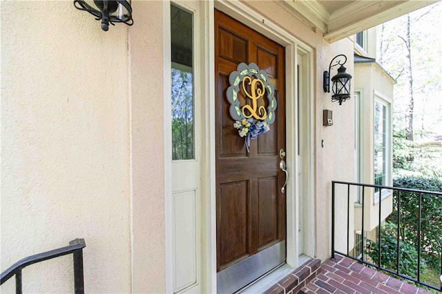 property entrance featuring stucco siding and a porch