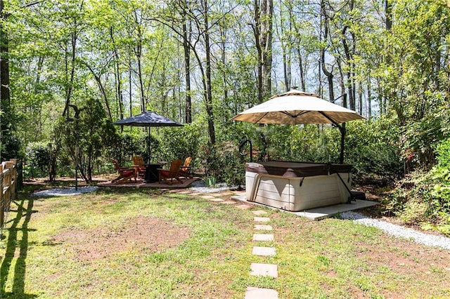 view of grassy yard with a hot tub
